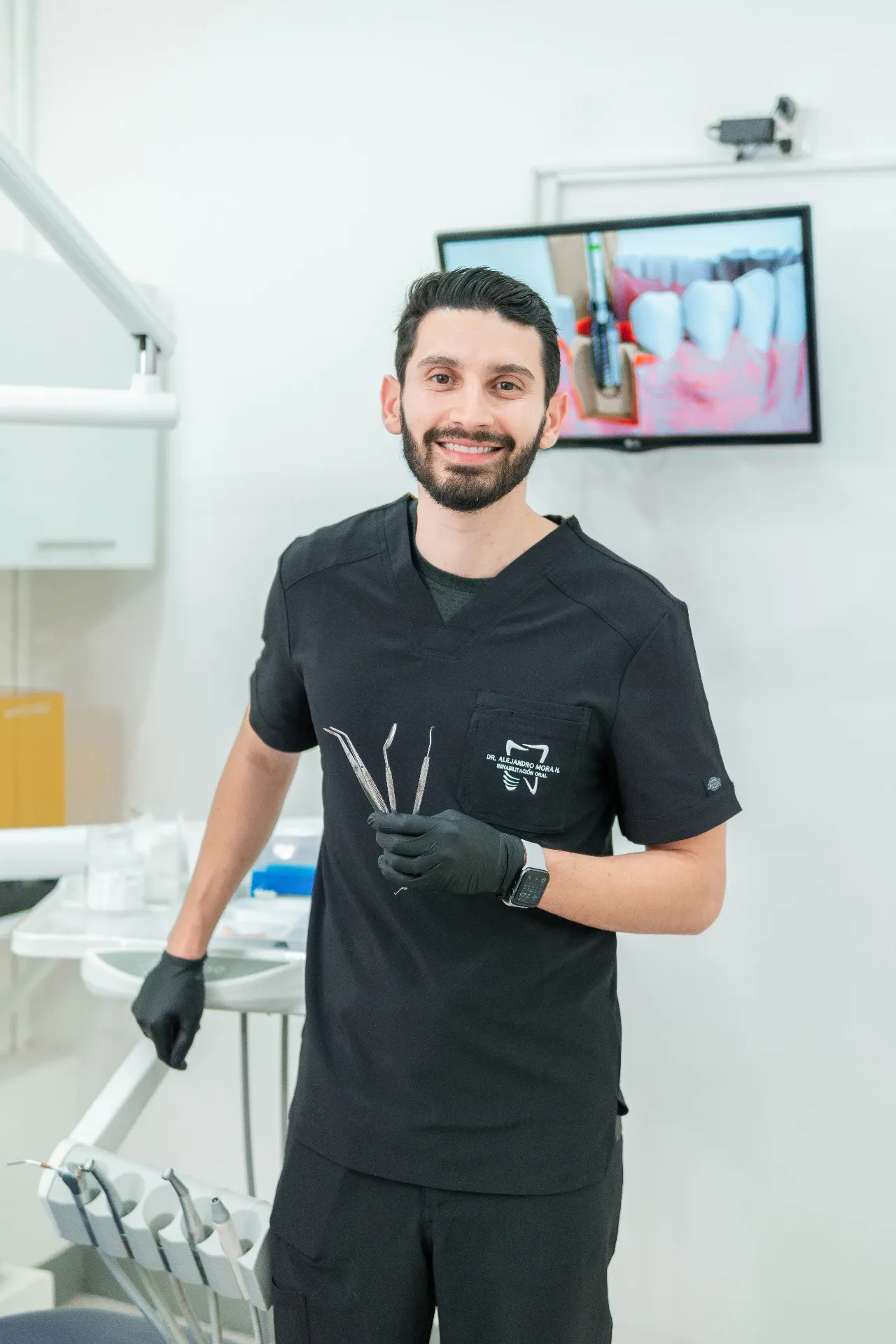 Confident dental professional holding dental instruments in a modern clinical environment
